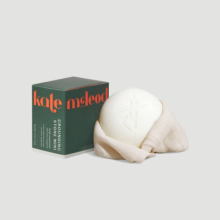 Kate McLeod grounding stone ball with packaging on a light gray background
