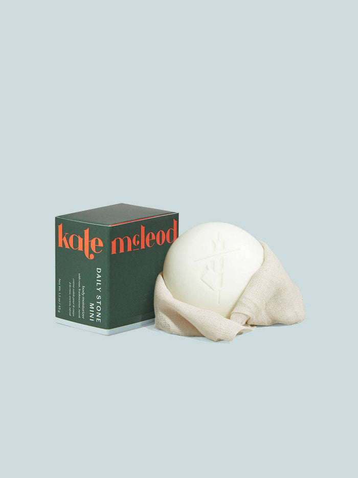 White stone and green 'kate mcLeod' box on a light gray background