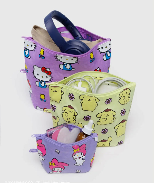 Three colorful fabric storage bins with cartoon designs on a white background
