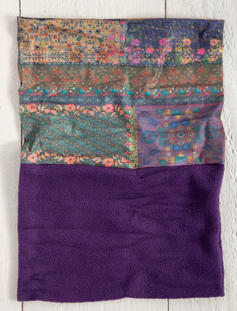 Folded fabric with patchwork pattern on a purple background