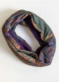 Multicolored patterned infinity scarf on a white background